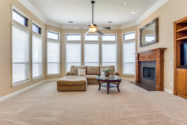 living room with crown molding, carpet, a wealth of natural light, and ceiling fan