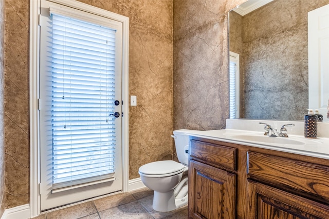 bathroom featuring vanity, tile patterned floors, and toilet