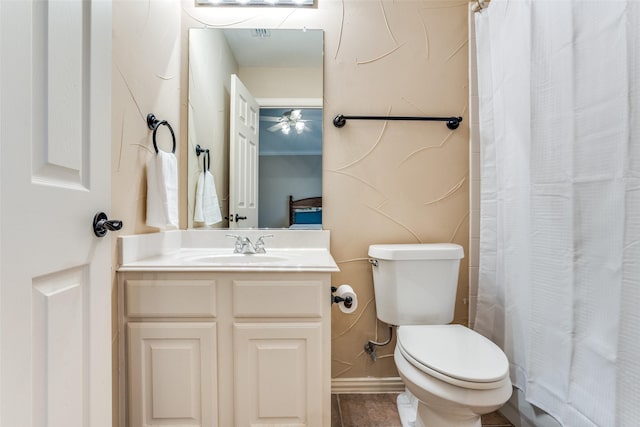 bathroom with vanity, a shower with shower curtain, and toilet