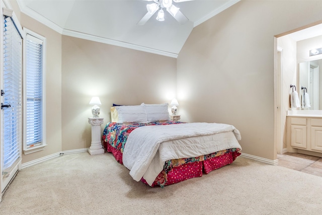 bedroom with ceiling fan, ensuite bathroom, ornamental molding, light carpet, and vaulted ceiling