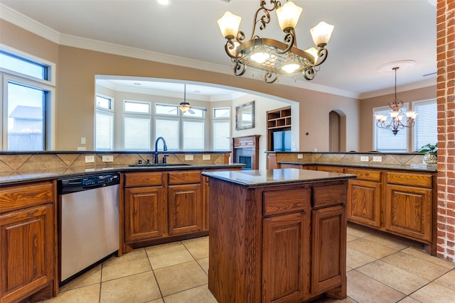 kitchen with sink, hanging light fixtures, light tile patterned floors, dishwasher, and backsplash