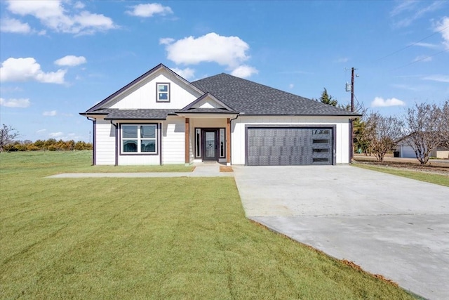 view of front of house with a garage and a front lawn