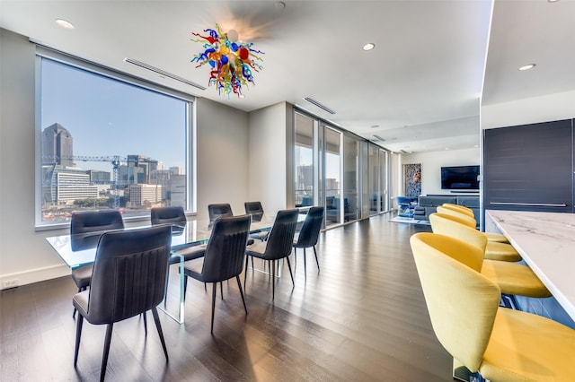 dining area with dark hardwood / wood-style flooring, plenty of natural light, and floor to ceiling windows