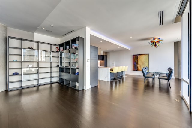 2408 Victory Park Ln Unit 1037, Dallas, TX 75219 - living area with dark wood finished floors, recessed lighting, and baseboards