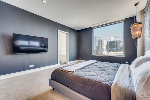 2408 Victory Park Ln Unit 1037, Dallas, TX 75219 - bedroom featuring carpet, baseboards, recessed lighting, and ensuite bathroom
