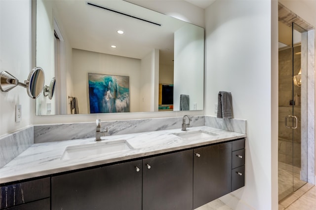 bathroom featuring tile patterned floors, vanity, and a shower with door