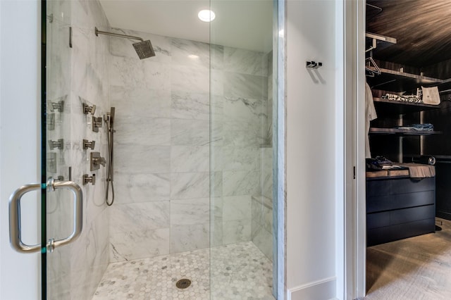 bathroom featuring a shower with door