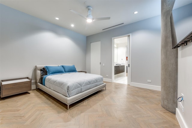 bedroom featuring ceiling fan, light parquet flooring, and ensuite bathroom