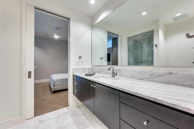 bathroom with vanity, parquet floors, and a shower with shower door