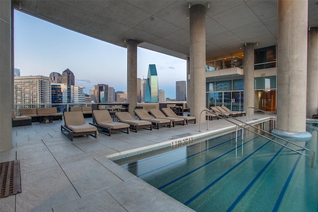 2408 Victory Park Ln Unit 1037, Dallas, TX 75219 - community pool featuring a skyline view, an outdoor hangout area, and a patio area