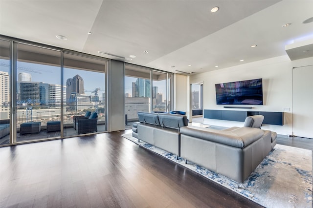 living room with hardwood / wood-style flooring and a wall of windows