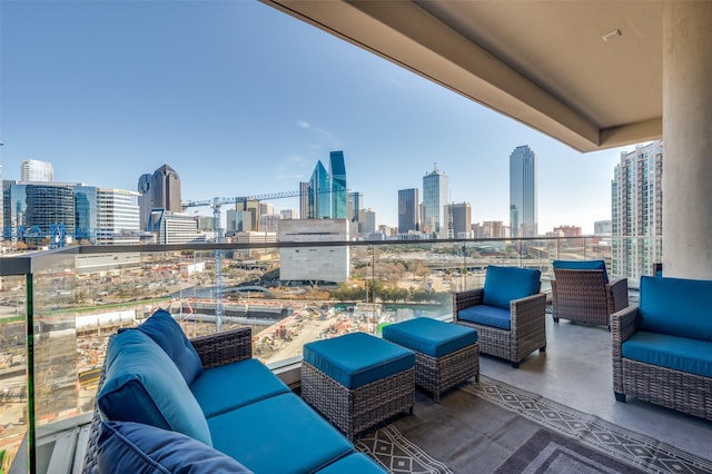 2408 Victory Park Ln Unit 1037, Dallas, TX 75219 - view of patio featuring a balcony, a skyline view, and an outdoor hangout area
