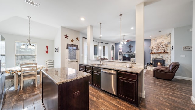 kitchen featuring dark wood-type flooring, dark brown cabinetry, sink, a center island, and dishwasher