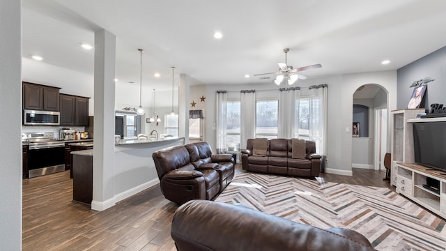 living room featuring dark hardwood / wood-style floors and ceiling fan