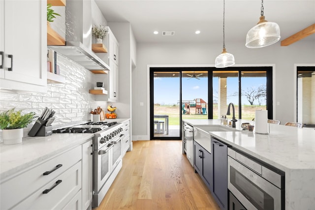 kitchen with white cabinetry, pendant lighting, stainless steel appliances, and exhaust hood