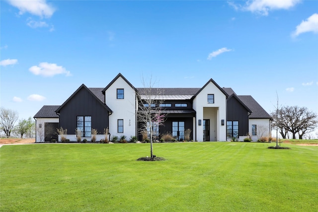 rear view of house featuring a yard