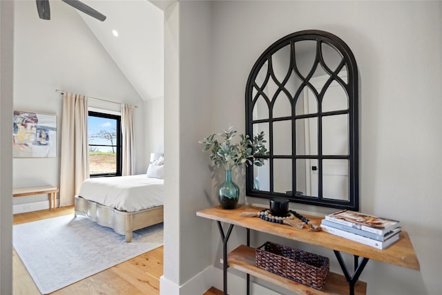 bedroom featuring high vaulted ceiling and hardwood / wood-style floors