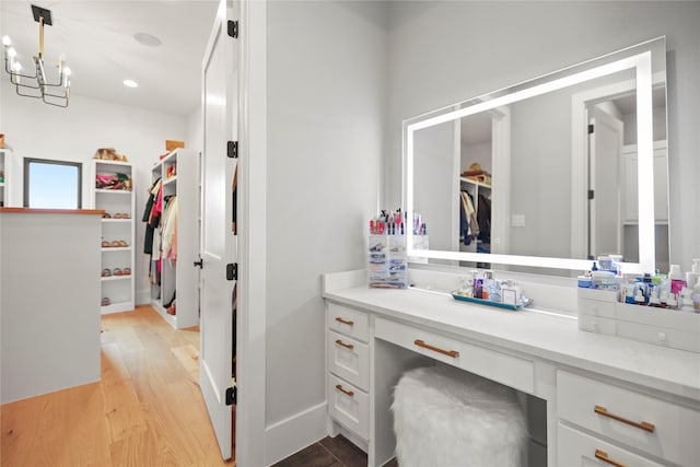 bathroom featuring vanity, hardwood / wood-style floors, and a chandelier