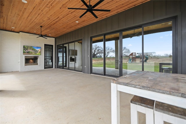 view of patio / terrace featuring a fireplace and ceiling fan