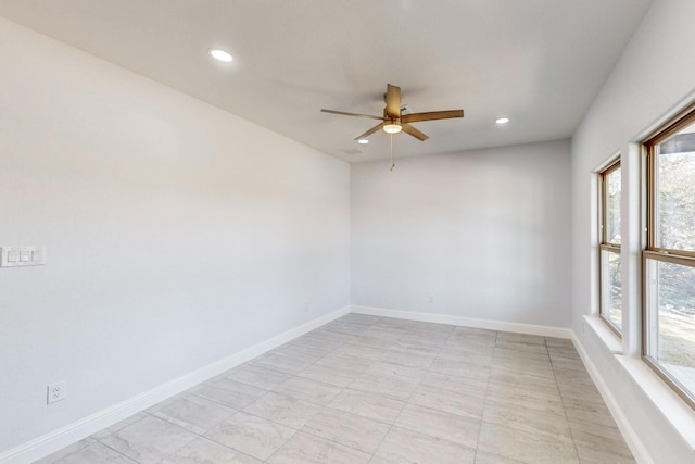 empty room featuring plenty of natural light and ceiling fan