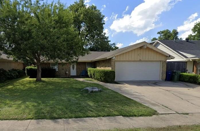 ranch-style house with a garage and a front yard