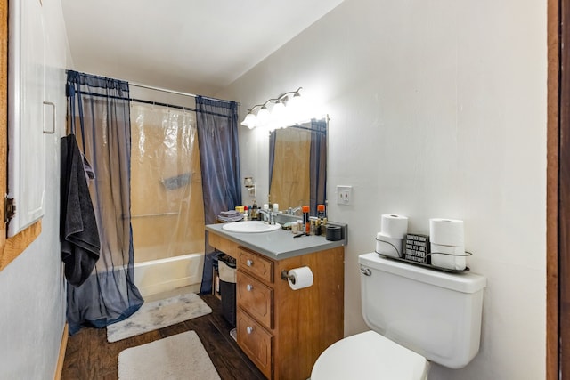 full bathroom with hardwood / wood-style flooring, shower / bath combo, vanity, and toilet