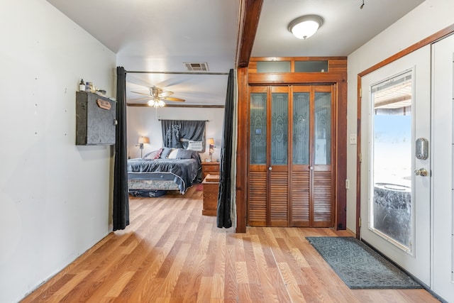 foyer entrance featuring ceiling fan and light wood-type flooring