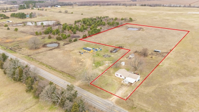 birds eye view of property with a rural view