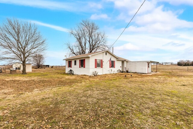 single story home with a carport, a front yard, and cooling unit