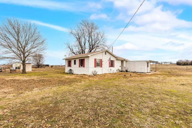 view of side of property with a lawn