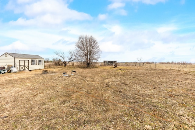 view of yard with a rural view