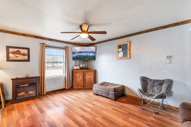 sitting room with light hardwood / wood-style floors and ceiling fan