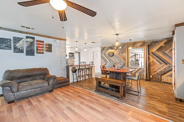 living room with ceiling fan and light wood-type flooring