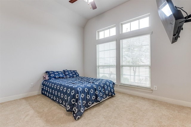 carpeted bedroom featuring ceiling fan, lofted ceiling, and multiple windows