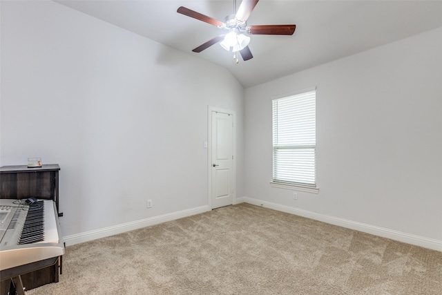 carpeted empty room featuring lofted ceiling and ceiling fan