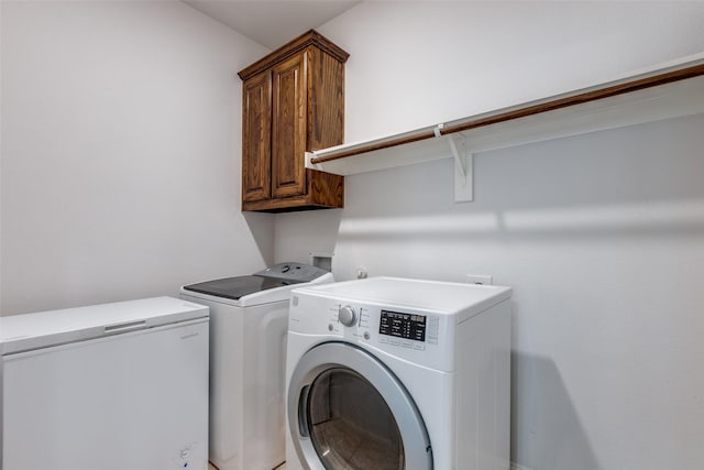 laundry area featuring cabinets and washing machine and dryer