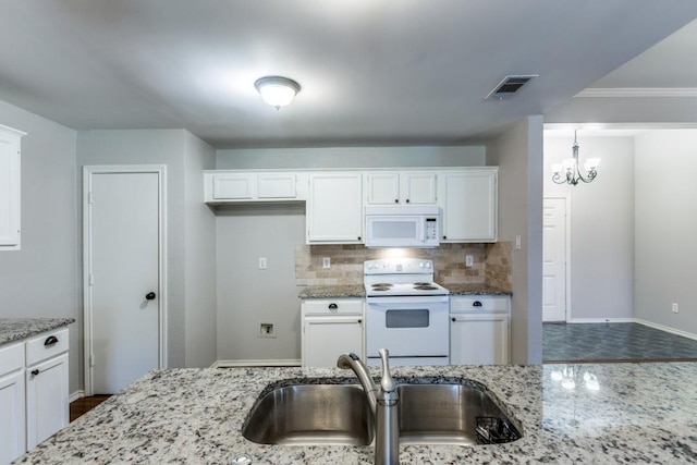 kitchen with sink, white cabinets, and white appliances