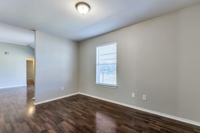 spare room with dark wood-type flooring