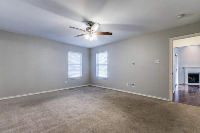 carpeted empty room featuring ceiling fan