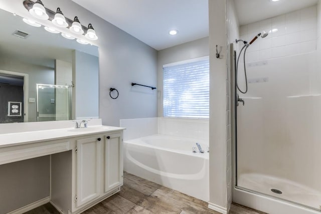 bathroom with shower with separate bathtub and vanity