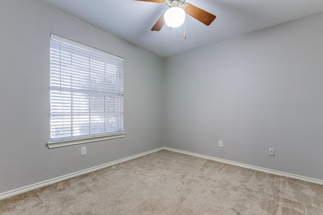 empty room with ceiling fan and light colored carpet