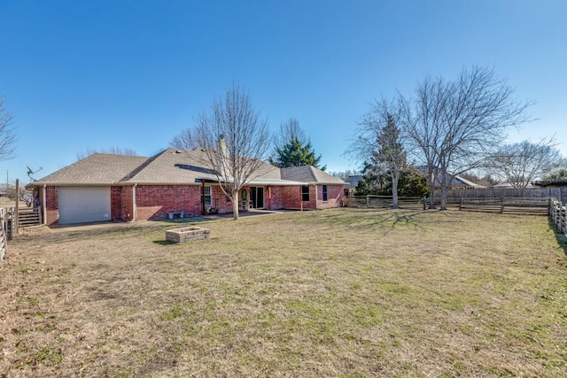 ranch-style house featuring a garage and a front yard