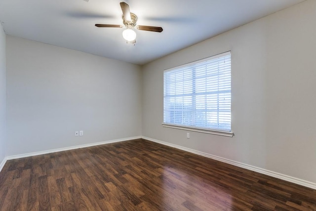 empty room featuring ceiling fan and dark hardwood / wood-style flooring