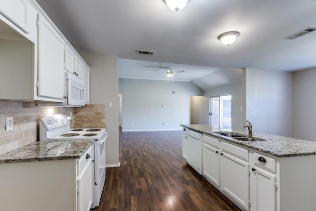 kitchen featuring tasteful backsplash, sink, white cabinets, light stone countertops, and white appliances