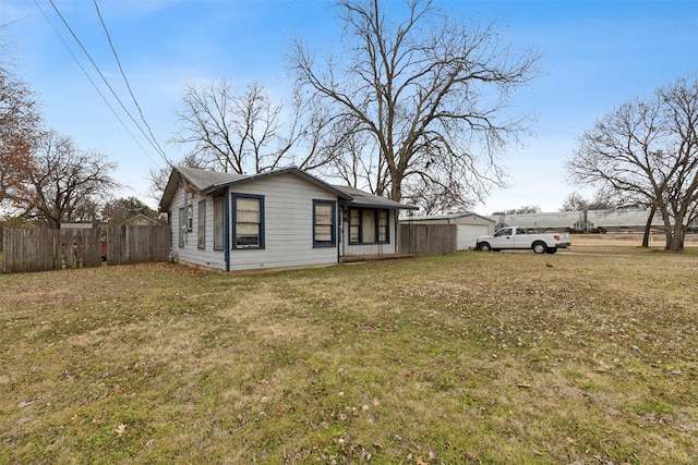 view of side of property with a garage and a lawn