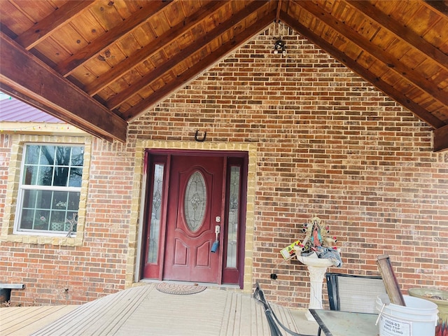 property entrance featuring brick siding