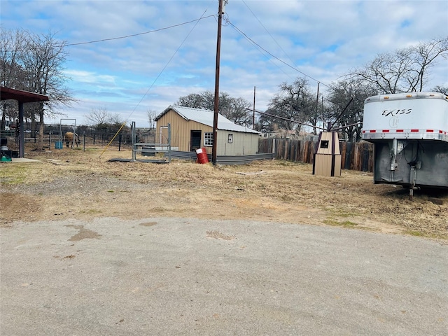 view of yard with fence and an outdoor structure