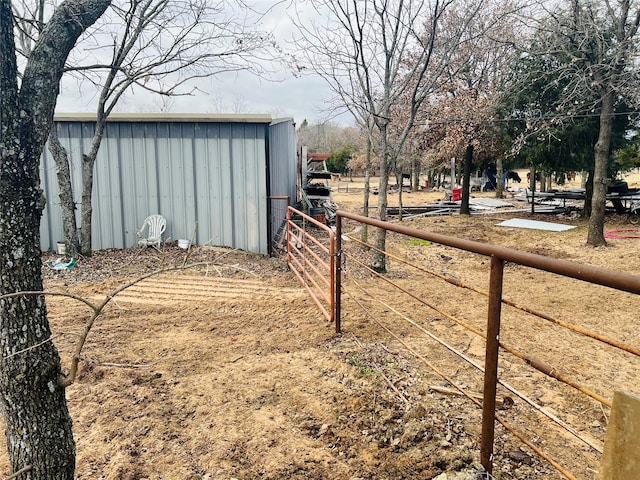 view of yard featuring an outdoor structure and fence