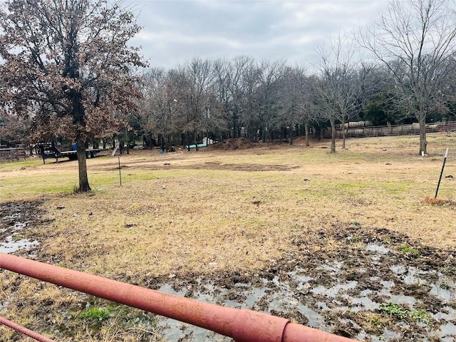 view of yard with a rural view and fence