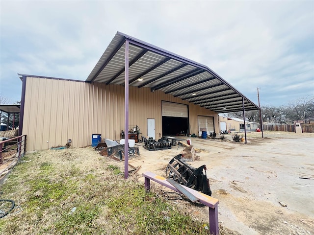 view of pole building with fence